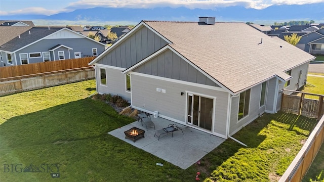 1711 Shelby Ave, Belgrade, MT 59714 - back of property featuring board and batten siding, a fire pit, roof with shingles, and a residential view