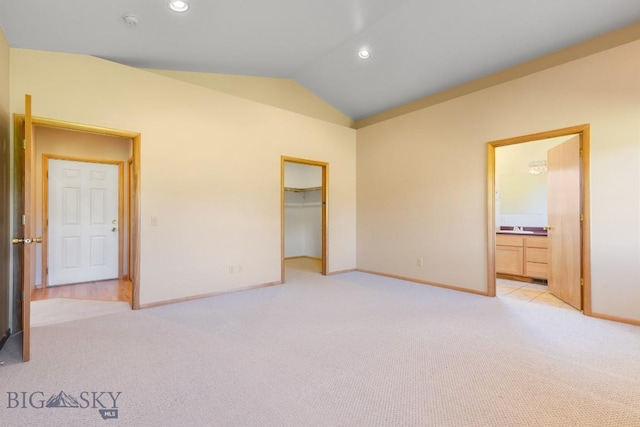 41 Madison, Ennis, MT 59729 - unfurnished bedroom with light colored carpet, vaulted ceiling, baseboards, recessed lighting, and ensuite bathroom