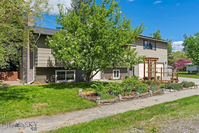 707 Montana St, Belgrade, MT 59714 - view of front facade featuring a garage, concrete driveway, and a chimney