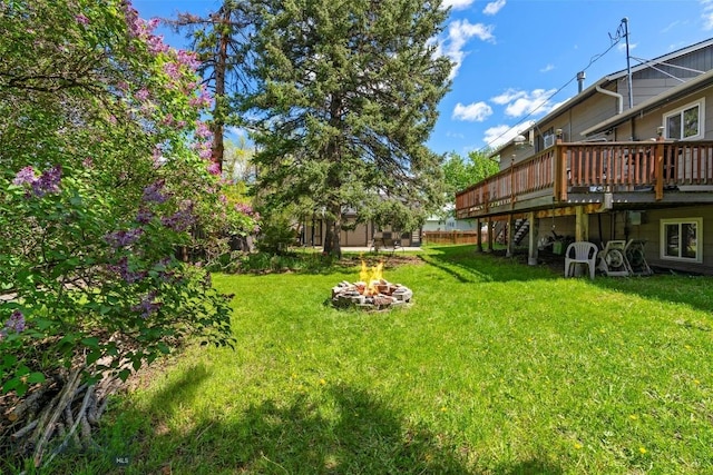 707 Montana St, Belgrade, MT 59714 - view of green lawn featuring a fire pit, a deck, and stairs
