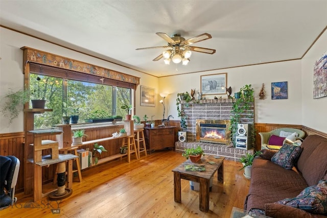 707 Montana St, Belgrade, MT 59714 - living room with a wainscoted wall, ceiling fan, wood-type flooring, a brick fireplace, and wood walls