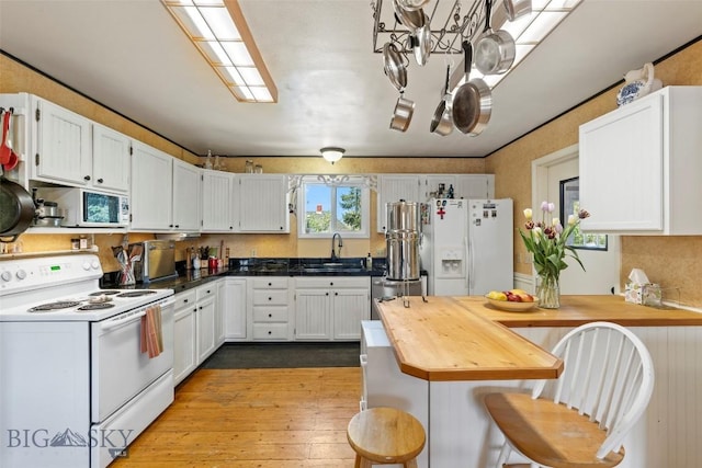 707 Montana St, Belgrade, MT 59714 - kitchen with white appliances, a sink, white cabinetry, and wood counters