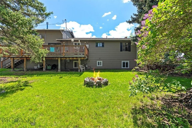 707 Montana St, Belgrade, MT 59714 - rear view of house with a wooden deck, a fire pit, a lawn, and stairs