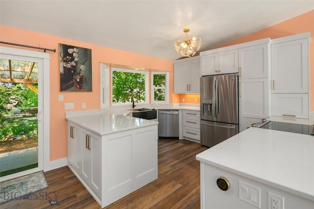 307 Flathead Ave, Bozeman, MT 59718 - kitchen with stainless steel appliances, a peninsula, a sink, healthy amount of natural light, and vaulted ceiling