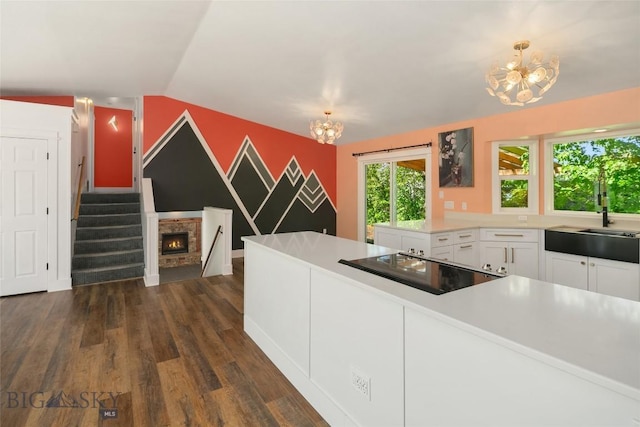 307 Flathead Ave, Bozeman, MT 59718 - kitchen featuring a chandelier, a sink, dark wood-type flooring, white cabinetry, and black electric cooktop