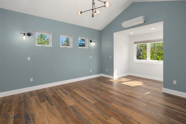 307 Flathead Ave, Bozeman, MT 59718 - unfurnished room featuring an AC wall unit, a chandelier, baseboards, wood finished floors, and high vaulted ceiling