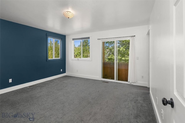 307 Flathead Ave, Bozeman, MT 59718 - unfurnished room featuring baseboards and dark carpet