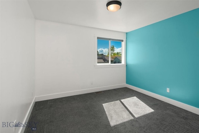307 Flathead Ave, Bozeman, MT 59718 - unfurnished room featuring dark carpet and baseboards