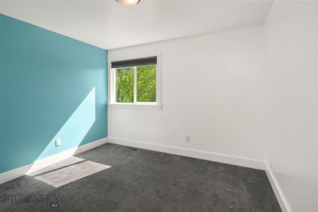 307 Flathead Ave, Bozeman, MT 59718 - empty room with dark colored carpet and baseboards