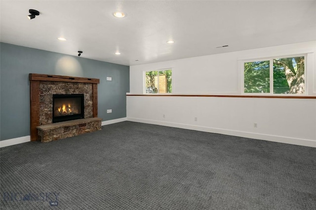 307 Flathead Ave, Bozeman, MT 59718 - unfurnished living room featuring a fireplace, recessed lighting, dark carpet, and baseboards