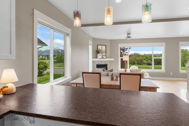 5333 Westmorland Dr, Bozeman, MT 59718 - dining area featuring a stone fireplace and ceiling fan