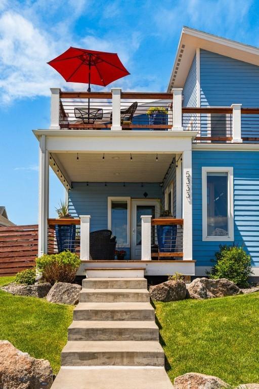 5333 Westmorland Dr, Bozeman, MT 59718 - rear view of property featuring a balcony, a porch, and a lawn