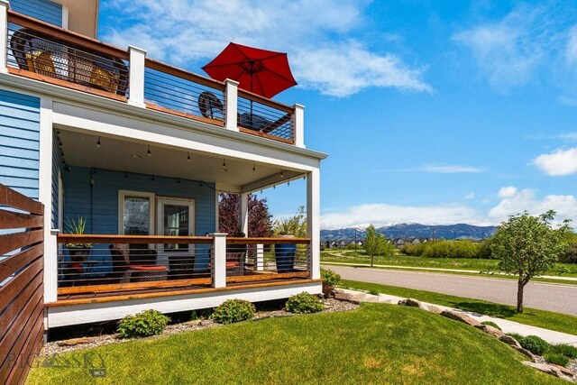 5333 Westmorland Dr, Bozeman, MT 59718 - view of side of home featuring a balcony, a mountain view, a yard, and covered porch