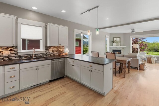5333 Westmorland Dr, Bozeman, MT 59718 - kitchen with dishwasher, a sink, dark countertops, light wood-type flooring, and recessed lighting
