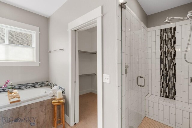 5333 Westmorland Dr, Bozeman, MT 59718 - bathroom featuring a stall shower, a bath, and a spacious closet