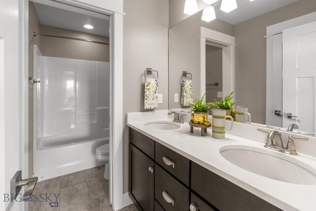 5333 Westmorland Dr, Bozeman, MT 59718 - bathroom with toilet, double vanity, and shower / washtub combination