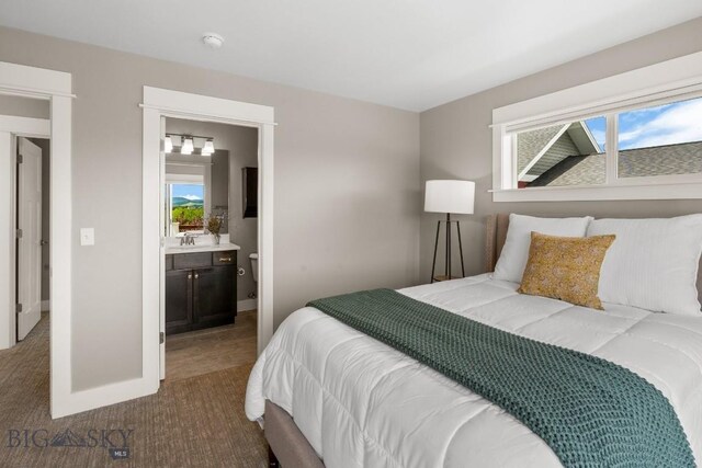5333 Westmorland Dr, Bozeman, MT 59718 - carpeted bedroom featuring a sink, baseboards, and ensuite bathroom