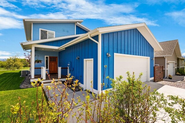 5333 Westmorland Dr, Bozeman, MT 59718 - view of front of home featuring an attached garage, board and batten siding, concrete driveway, and a porch