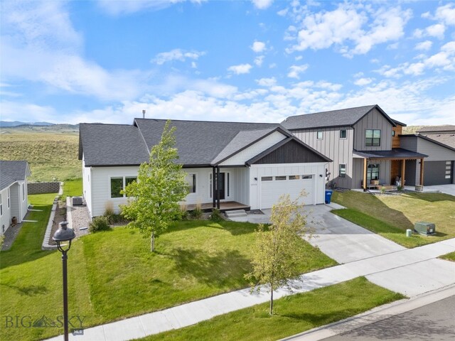 1215 Sweetgrass Ln, Livingston, MT 59047 - modern farmhouse style home with board and batten siding, concrete driveway, an attached garage, and a front lawn