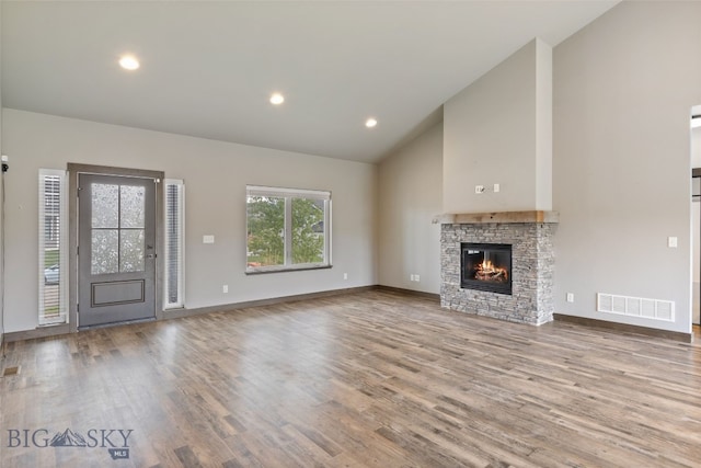 1215 Sweetgrass Ln, Livingston, MT 59047 - unfurnished living room with wood finished floors, a fireplace, baseboards, high vaulted ceiling, and recessed lighting