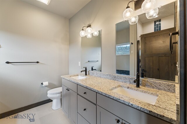 1215 Sweetgrass Ln, Livingston, MT 59047 - full bath with double vanity, toilet, baseboards, tile patterned floors, and a shower