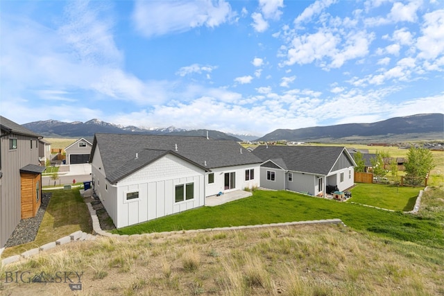 1215 Sweetgrass Ln, Livingston, MT 59047 - back of house featuring board and batten siding, a mountain view, a lawn, and a patio area