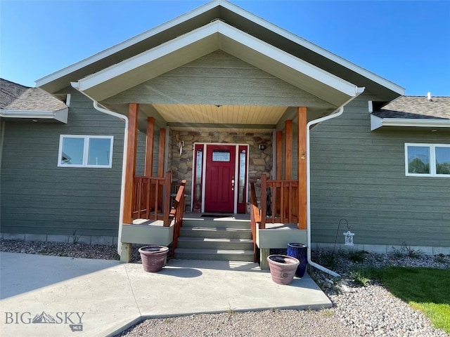30 Harris Hawk Ct, Dillon, MT 59725 - view of exterior entry with a shingled roof and a porch