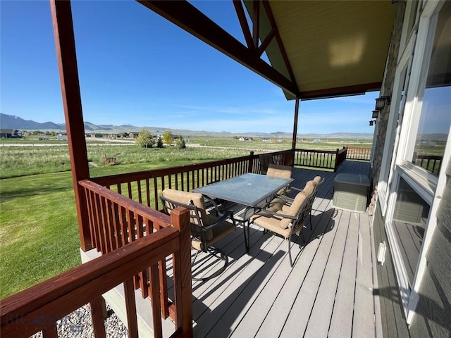 30 Harris Hawk Ct, Dillon, MT 59725 - wooden terrace with a view of countryside, outdoor dining space, a lawn, and a mountain view