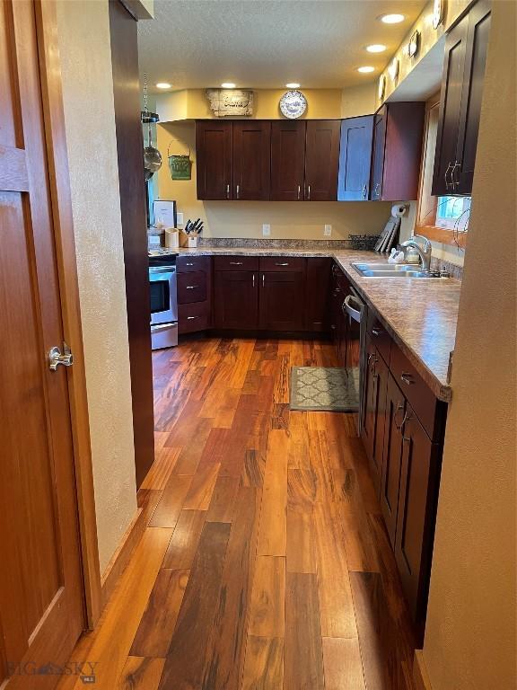 30 Harris Hawk Ct, Dillon, MT 59725 - kitchen with a sink, dark wood-type flooring, electric stove, light countertops, and dark brown cabinets