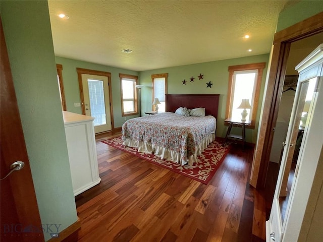 30 Harris Hawk Ct, Dillon, MT 59725 - bedroom featuring multiple windows, wood finished floors, a textured ceiling, baseboards, and recessed lighting