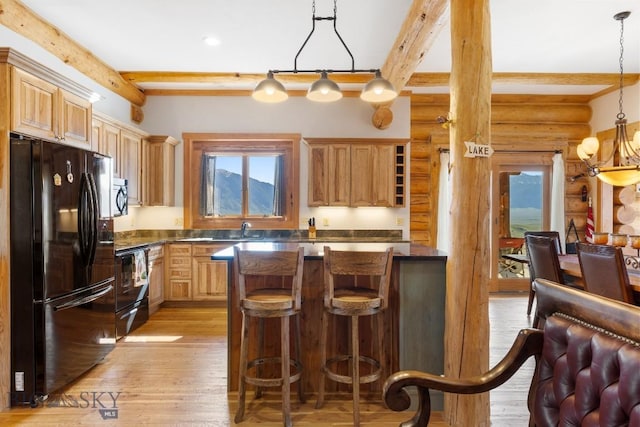 23 Lake Trl, Cameron, MT 59720 - kitchen featuring black appliances, healthy amount of natural light, beam ceiling, dark countertops, and log walls