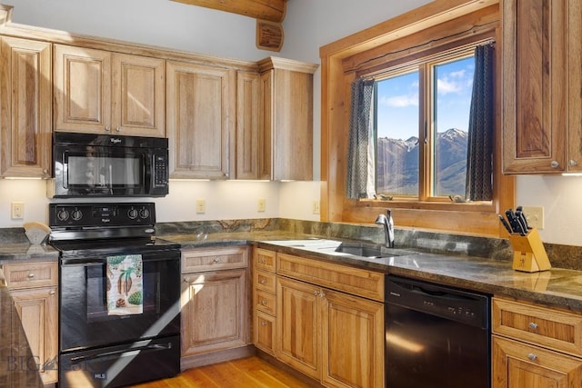 23 Lake Trl, Cameron, MT 59720 - kitchen with black appliances, a sink, light wood-type flooring, and dark stone counters