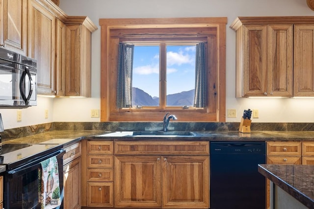 23 Lake Trl, Cameron, MT 59720 - kitchen with black appliances, a sink, brown cabinetry, and a mountain view