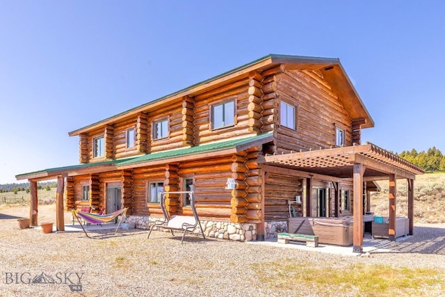 23 Lake Trl, Cameron, MT 59720 - back of house featuring log exterior, a hot tub, and a patio area