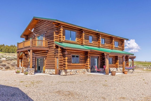 23 Lake Trl, Cameron, MT 59720 - view of front of house with log siding, a balcony, and a patio
