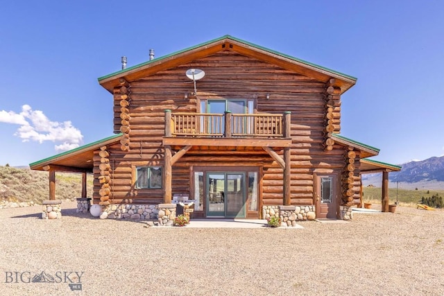 23 Lake Trl, Cameron, MT 59720 - back of property featuring log siding, a balcony, a mountain view, and stone siding