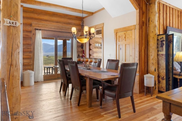 23 Lake Trl, Cameron, MT 59720 - dining area with a chandelier, a mountain view, light wood finished floors, and log walls