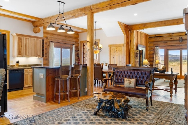 23 Lake Trl, Cameron, MT 59720 - kitchen featuring dishwasher, healthy amount of natural light, rustic walls, light wood-style floors, and beam ceiling