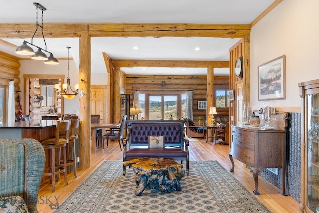 23 Lake Trl, Cameron, MT 59720 - living area featuring log walls, a chandelier, wood finished floors, beam ceiling, and recessed lighting