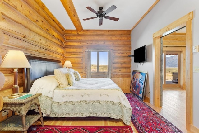 23 Lake Trl, Cameron, MT 59720 - bedroom with wood finished floors, rustic walls, a ceiling fan, and beam ceiling