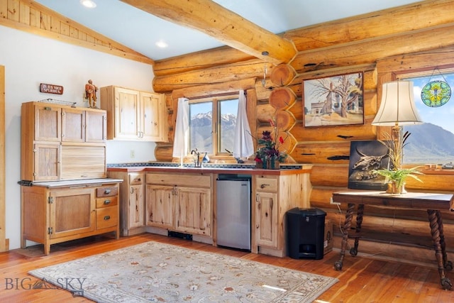 23 Lake Trl, Cameron, MT 59720 - kitchen featuring healthy amount of natural light, light wood finished floors, log walls, stainless steel dishwasher, and recessed lighting