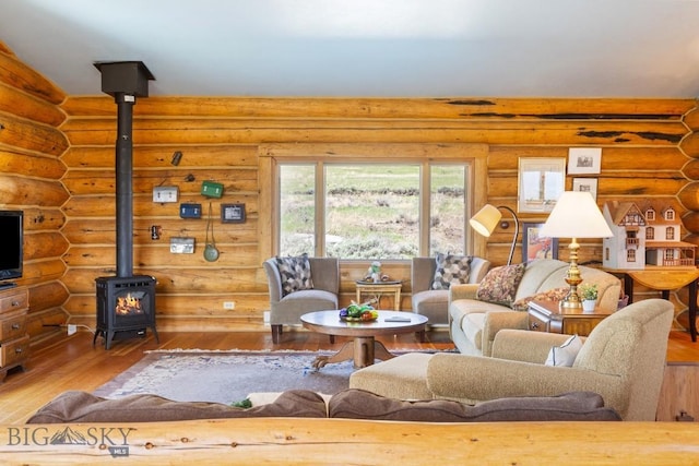 23 Lake Trl, Cameron, MT 59720 - living area featuring a wood stove, hardwood / wood-style flooring, and rustic walls