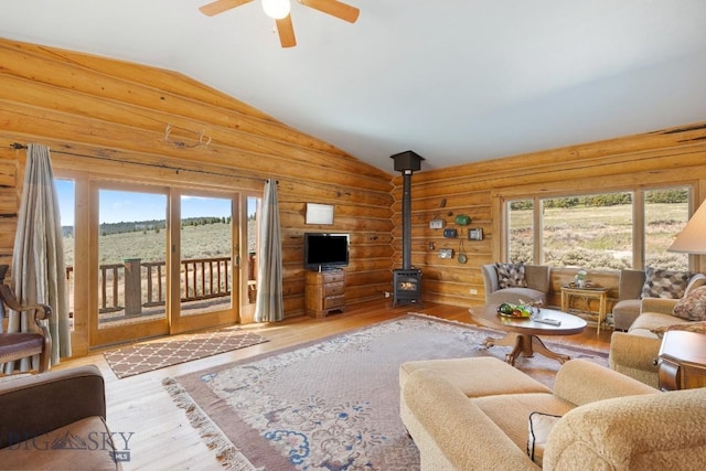 23 Lake Trl, Cameron, MT 59720 - living area with a wood stove, vaulted ceiling, wood finished floors, healthy amount of natural light, and ceiling fan