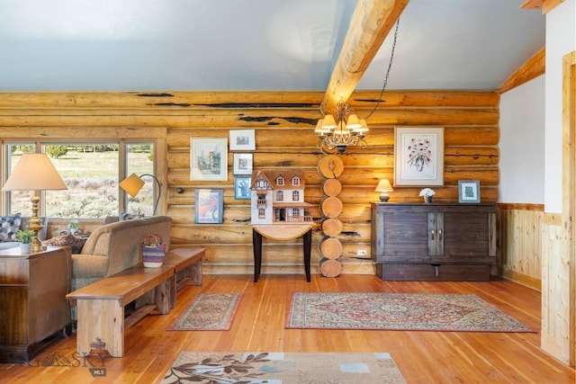 23 Lake Trl, Cameron, MT 59720 - living area featuring rustic walls, a chandelier, hardwood / wood-style floors, and beam ceiling