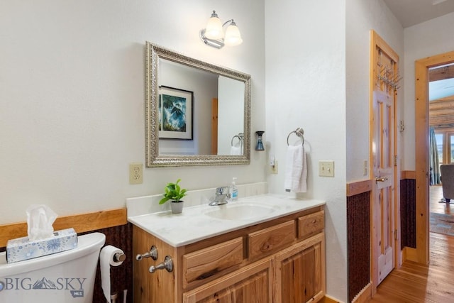 23 Lake Trl, Cameron, MT 59720 - half bathroom featuring toilet, vanity, and wood finished floors