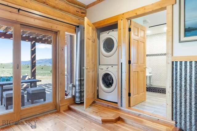23 Lake Trl, Cameron, MT 59720 - washroom with stacked washer / drying machine, wood finished floors, a mountain view, and french doors
