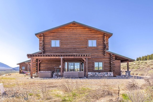23 Lake Trl, Cameron, MT 59720 - back of property featuring a hot tub, log siding, central AC unit, and a mountain view