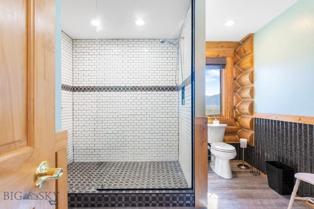 23 Lake Trl, Cameron, MT 59720 - bathroom featuring log walls, a stall shower, wood finished floors, and toilet