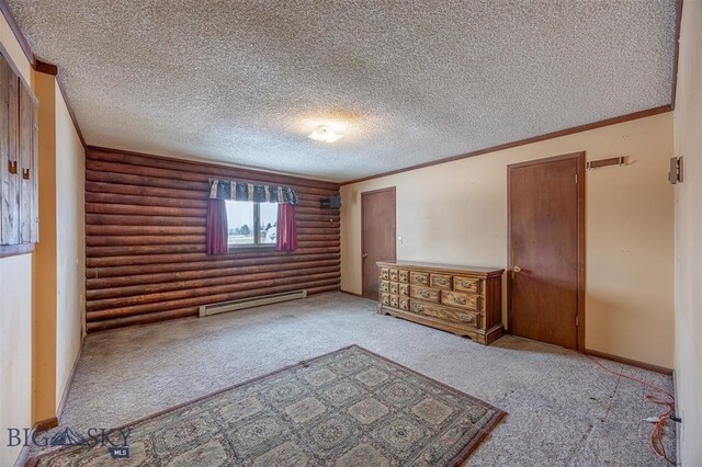 77 First Rd, Whitehall, MT 59759 - unfurnished bedroom featuring a baseboard heating unit, carpet, log walls, a textured ceiling, and baseboards