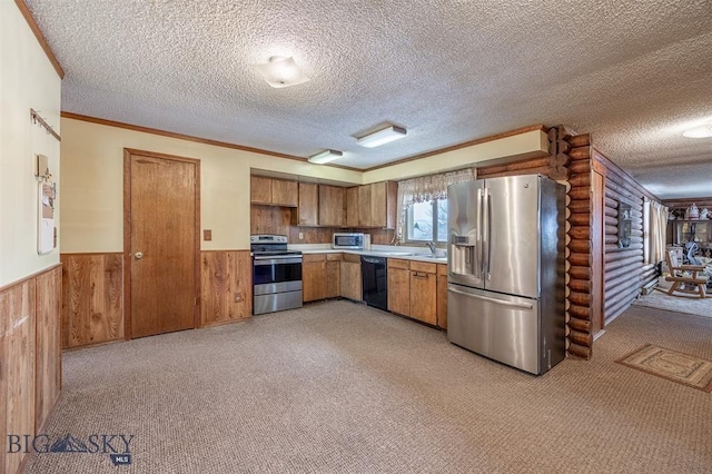 77 First Rd, Whitehall, MT 59759 - kitchen featuring stainless steel appliances, rustic walls, light countertops, a wainscoted wall, and a textured ceiling